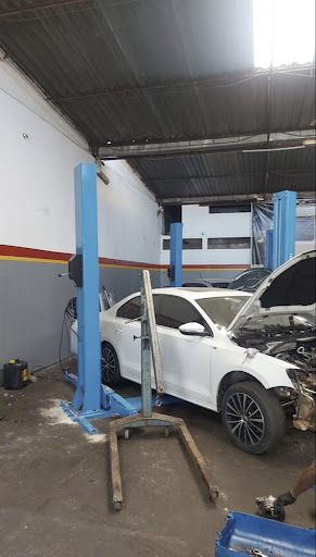 Carro branco dentro do box de serviço